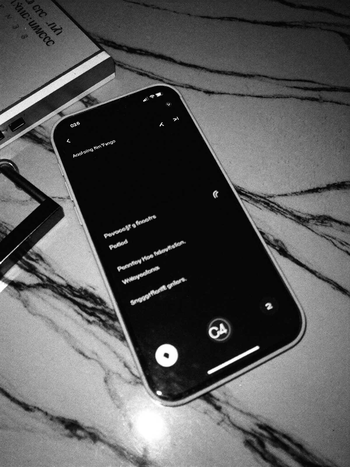 A phone lighting up with messages on a marble desk