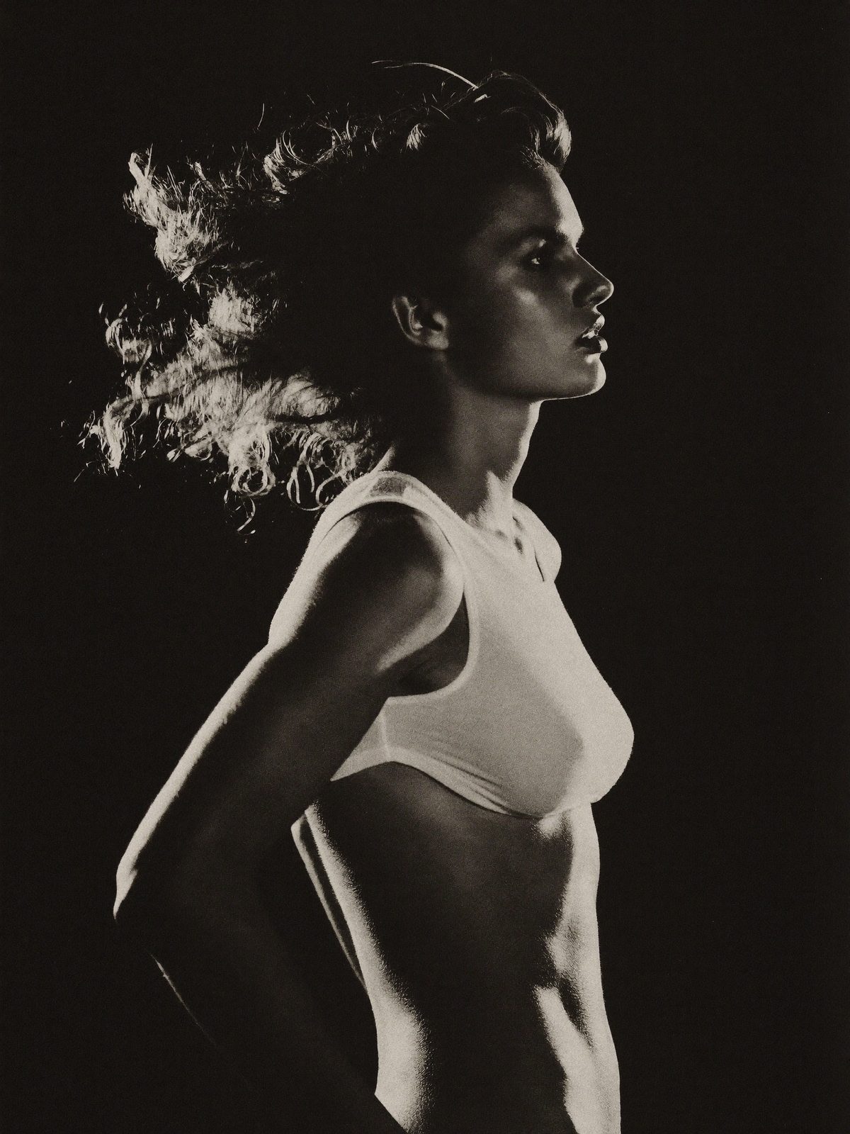 Editorial portrait of a creator in dramatic studio light