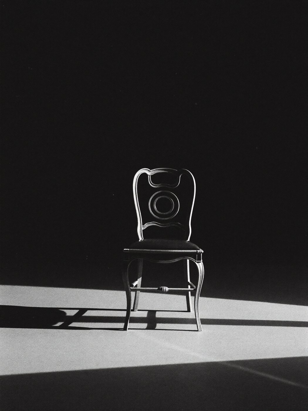 An empty chair in a shaft of light